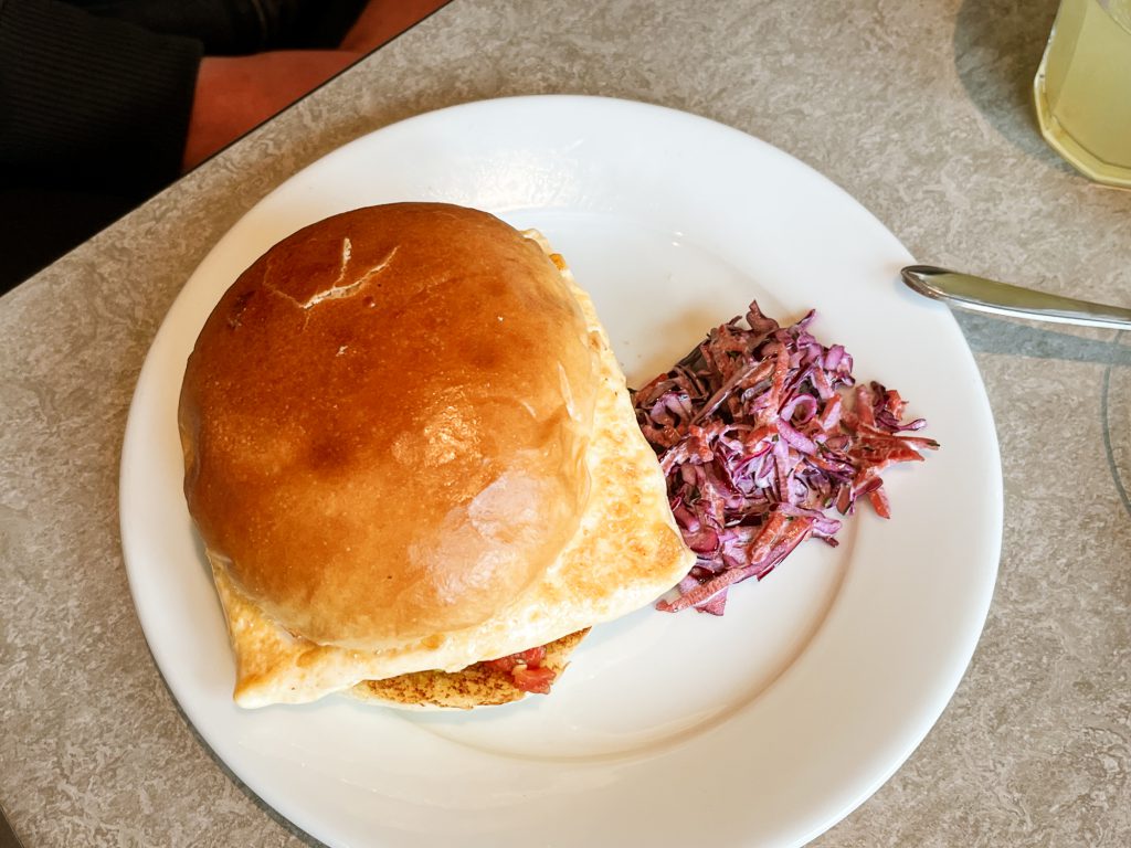 breakfast bun; egg and cheese sandwich with coleslaw on the side