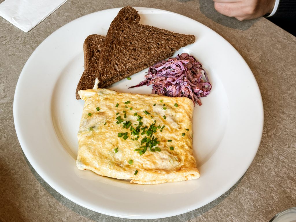 A okate of farmers omelette with toast and coleslaw