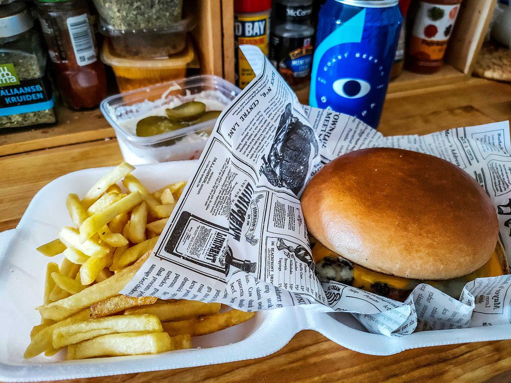 Frech fries with hamburger and a beer can