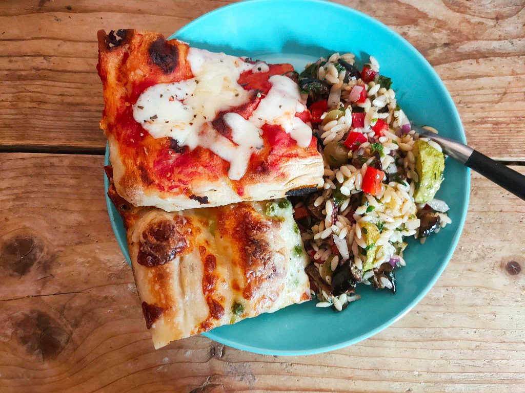 Plate with pizza slides and pasta salad